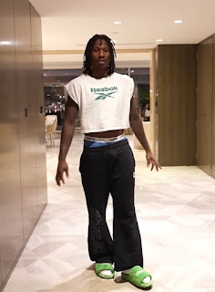 PHOTO Duke Dennis wearing Reebok crop top and green slides