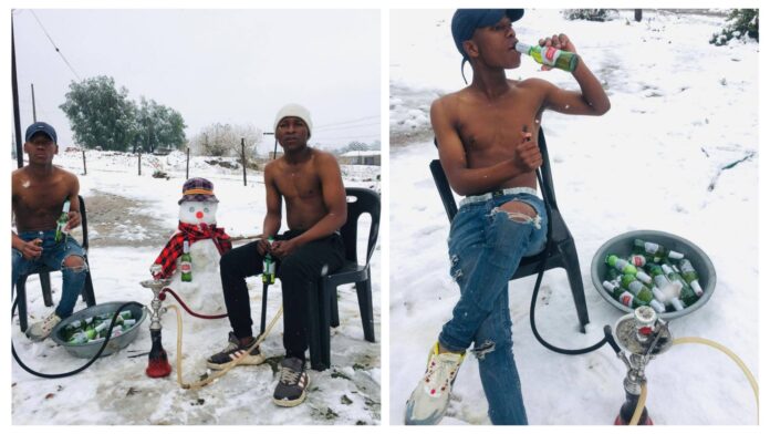 PHOTO: 2 South African guys seen drinking Stella Artois beer and smoking shisha on the road in traffic during snow on N3 Toll Route along Van Reenen