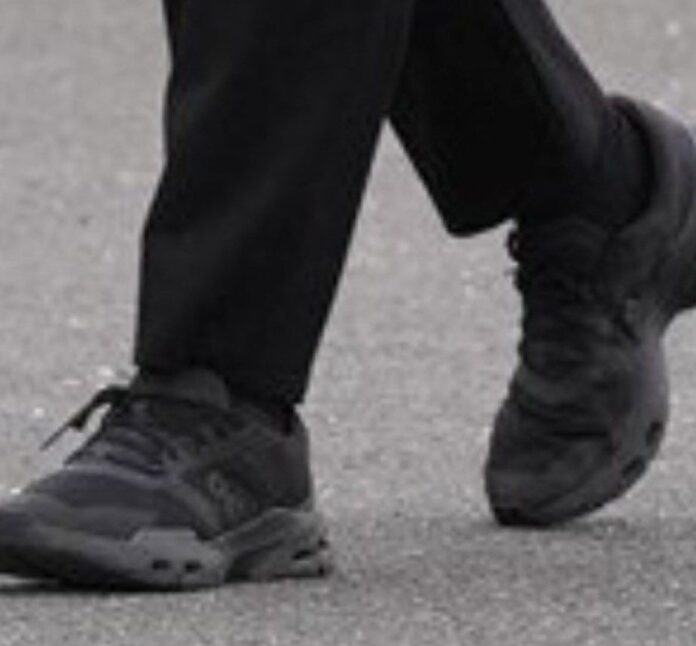 PHOTO: David Lammy wearing black trainers on suit to attend a meeting event