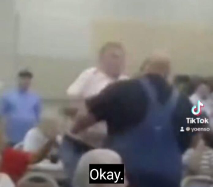 VIDEO: Guy in pink shirt, Jimme Cavin, knocked out big man, Jon Newcomb, wearing blue pinafore dress with heavy punch during MAGA REPUBLICAN party meeting at Saline County in Arkansas